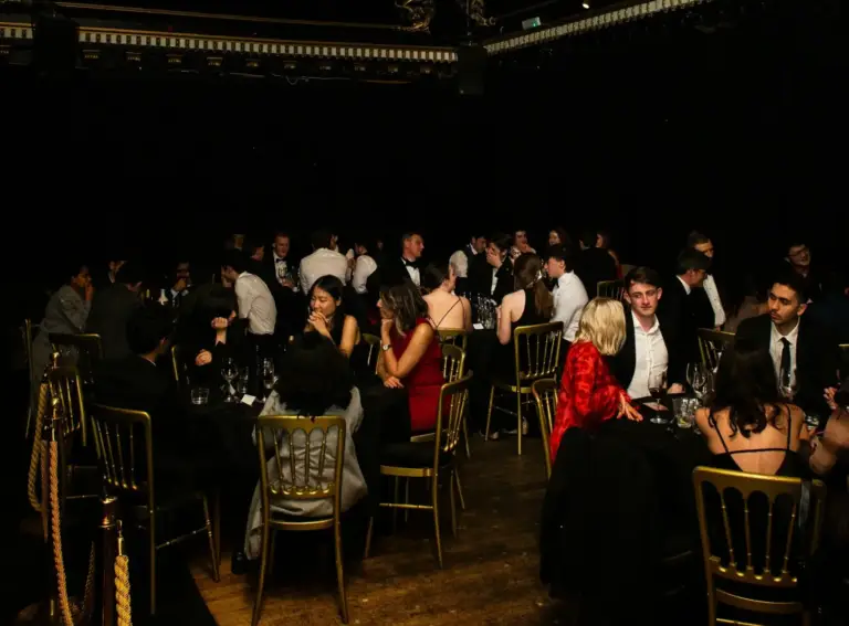 Group enjoying a luxury dinner party in Miami with fine dining, cocktails, and nightlife atmosphere