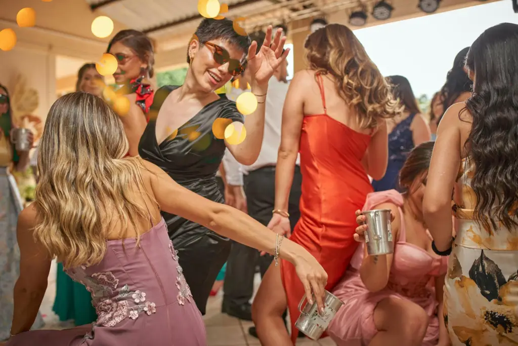 Partygoers dancing at a Miami day party with upbeat music and sunny vibes