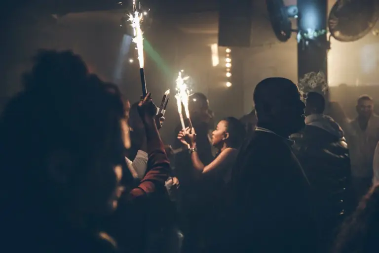 People celebrating a Miami nightlife party with lights, music, and energetic crowd