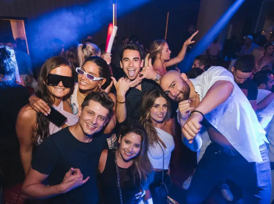 Miami nightclub experience with a lively party crowd, DJs, and vibrant club lighting