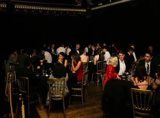 Group enjoying a luxury dinner party in Miami with fine dining, cocktails, and nightlife atmosphere