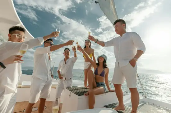 Group enjoying a yacht party in Miami with music, drinks, and skyline views