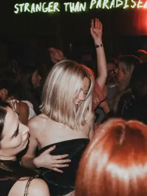 Crowd dancing inside a Miami nightclub with DJs, lights, and VIP atmosphere